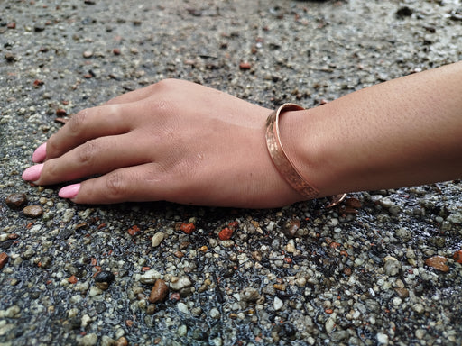 hand beaten copper bracelet in hand